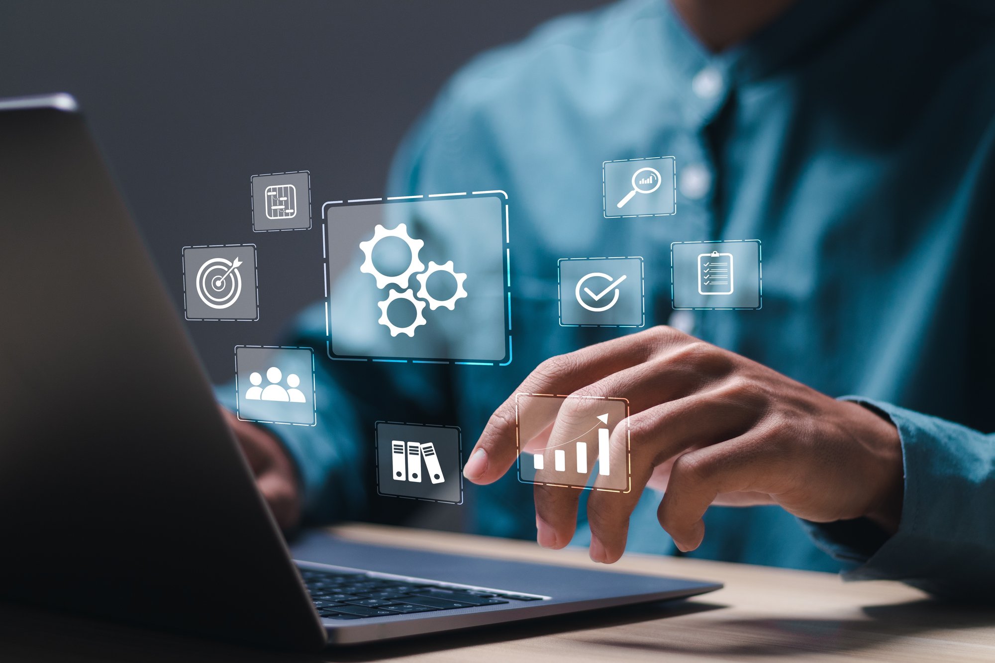 A man's hands are typing on a computer keyboard. Projected above the image is an interface displaying a cloud icon, symbolizing cloud-based solutions.